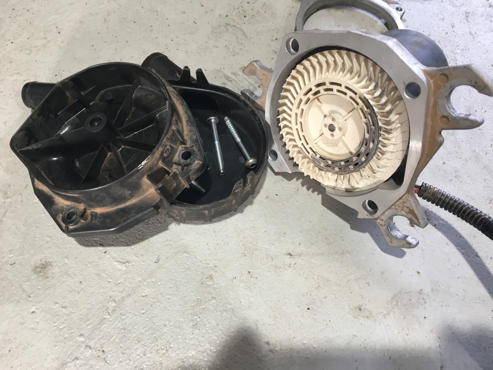 A cabin blower motor stripped out of its housing on the workshop floor