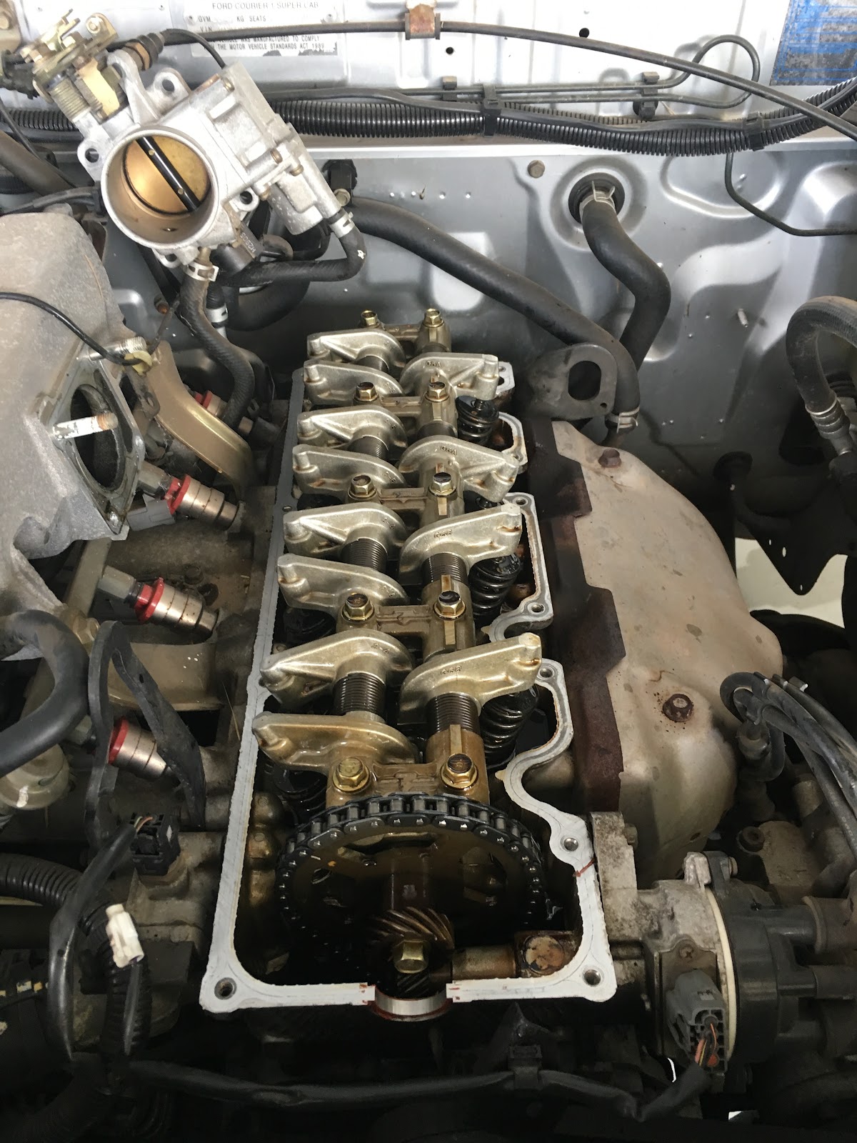 Rocker gear and timing chain exposed on a Ford Courier