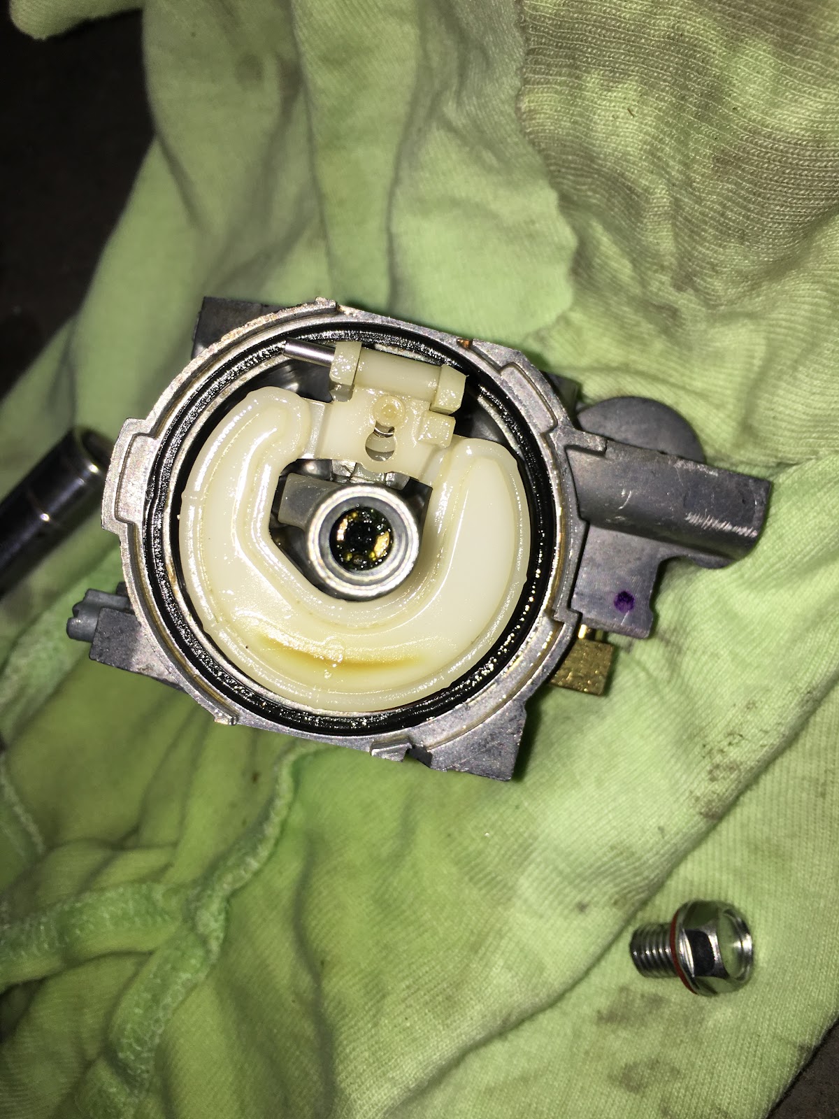 Thermostat housing opened on a rag with the seal visible